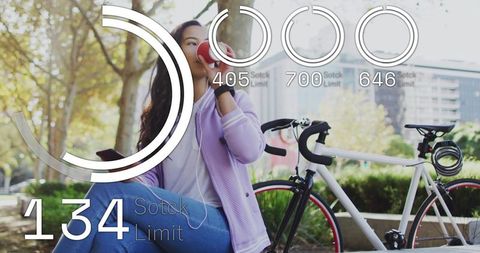 Young woman drinking from red cup on urban bench with bicycle and interactive hud overlays