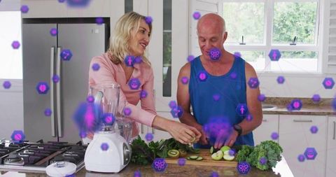 Mature couple preparing fresh produce together in bright kitchen with wellness tech overlay