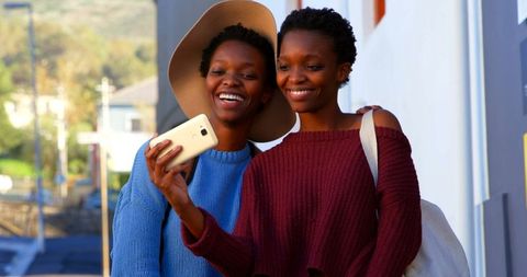 Twin Sisters Taking a Selfie on City Street - Download Free Stock Images Pikwizard.com