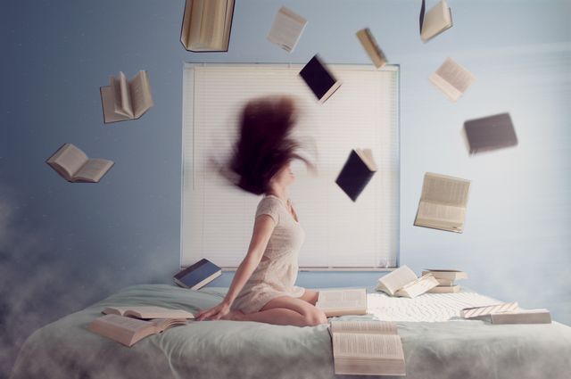 Woman Surrounded by Floating Books in Bedroom - Download Free Stock Images Pikwizard.com