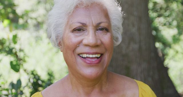 Portrait of happy senior biracial woman standing in garden smiling. Tranquility, senior lifestyle, nature and domestic life.