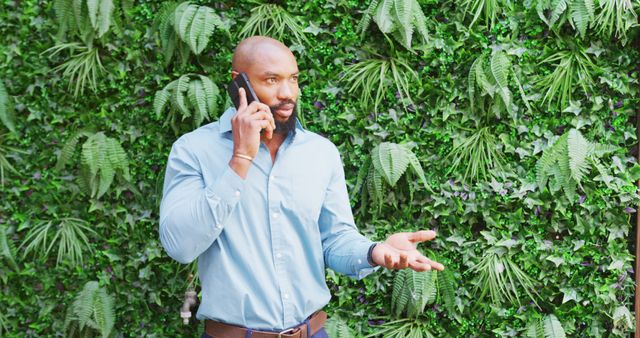 Confident Businessman Having Phone Conversation in Urban Green Space - Download Free Stock Images Pikwizard.com