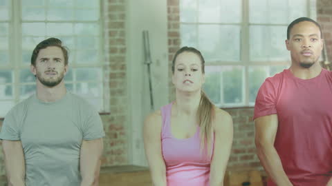 Diverse Group Exercising with Kettlebells in Gym