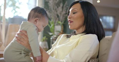 Loving Mother Bonding With Baby in Bright Scandinavian Living Room