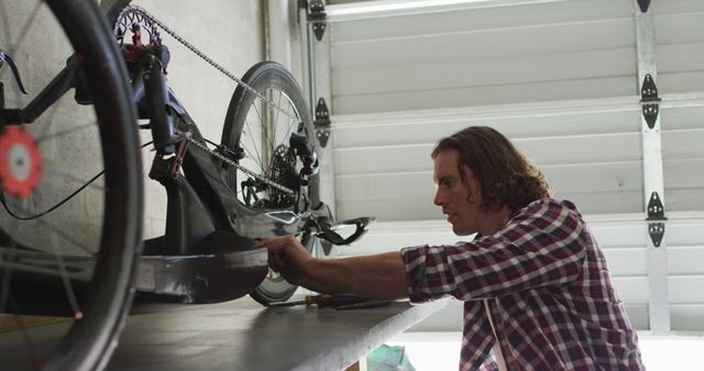 Man repairing bicycle in garage workshop - Download Free Stock Images Pikwizard.com