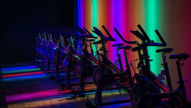 Neon Lit Exercise Bikes in Modern Fitness Studio