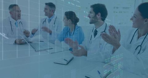 Healthcare team applauding after data presentation with laptop, charts and collaboration