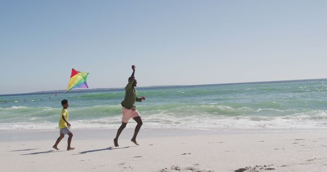 Father and Son Flying Kite on Beach - Download Free Stock Images Pikwizard.com