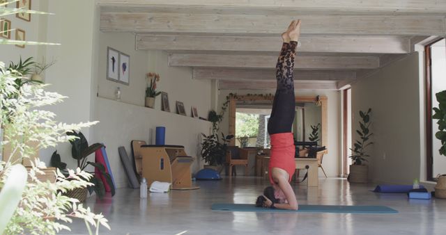 Woman Practicing Headstand in Modern Home Yoga Studio - Download Free Stock Images Pikwizard.com