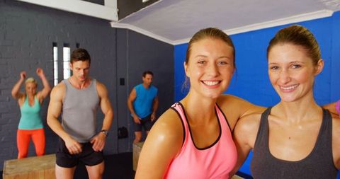 Energetic group fitness workout session with smiling participants