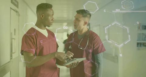 Diverse doctors using tablet with digital data overlay