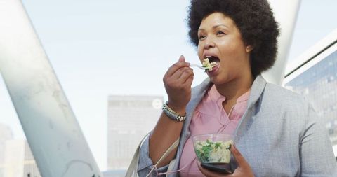 Plus Size Woman Enjoying Healthy Salad in Urban Setting