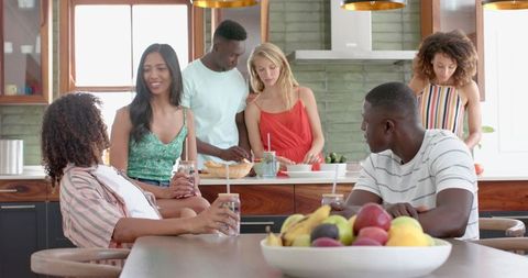 Diverse group of friends enjoying kitchen gathering