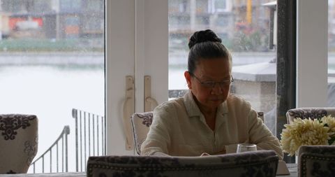 Senior Asian Woman Enjoying Quiet Moment by the Window