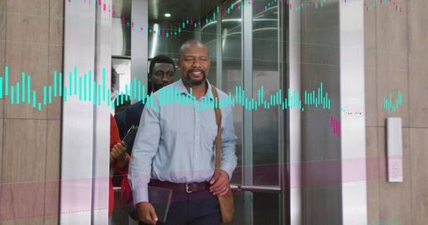 Smiling businessman walking out of elevator with shoulder bag and financial chart overlay