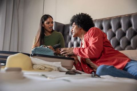 Couple packing for vacation with relaxing atmosphere