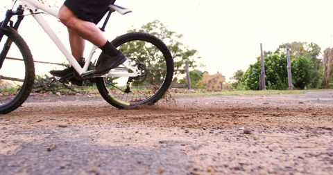Off-Road Cyclist Kicking Up Dust on Dirt Path Adventure - Download Free Stock Images Pikwizard.com