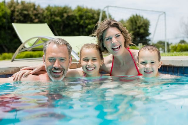Smiling family enjoying in swimming pool - Download Free Stock Photos Pikwizard.com