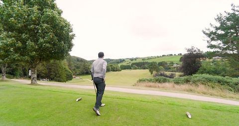 Male golfer surveying scenic fairway
