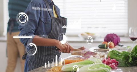 Man chopping vegetables with chef knife in modern kitchen with augmented reality overlays
