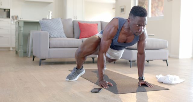 Young Man Exercising with Resistance Bands in Modern Living Room - Download Free Stock Images Pikwizard.com