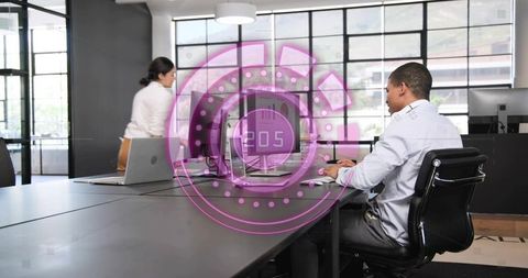 Man typing at open-plan desk with magenta ar hud overlay for modern workplace