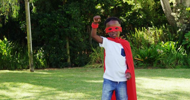 Young Child in Red Superhero Costume Raising Arm in Park - Download Free Stock Images Pikwizard.com