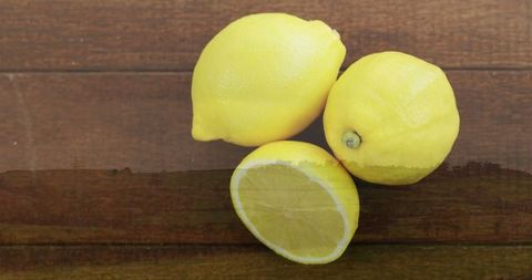 Bright Yellow Lemons on Rustic Wooden Tabletop