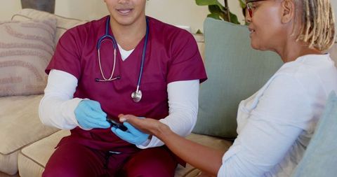 Nurse Checking Senior Woman's Blood Oxygen Levels at Home for Health Check