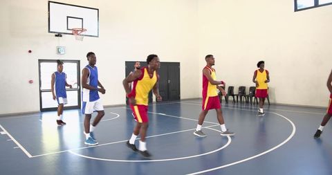 Intense Basketball Game on Indoor Court with Athletic Young Men