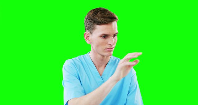 Male Nurse Interacting with Virtual Screen on Green Background - Download Free Stock Images Pikwizard.com