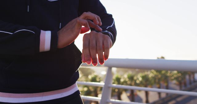 Runner Using Smartwatch for Tracking Outdoor Workout on Sunny Day - Download Free Stock Images Pikwizard.com