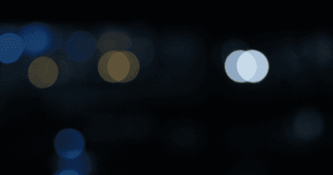 defocused illuminated bokeh lights on transparent dark night sky - Download Free Stock Videos Pikwizard.com
