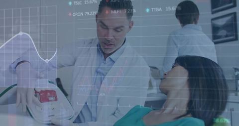 Dentist demonstrating dental device to patient with data overlays showing diagnostics