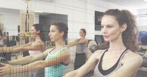 Women harnessing suspension workouts for core strength in modern gym