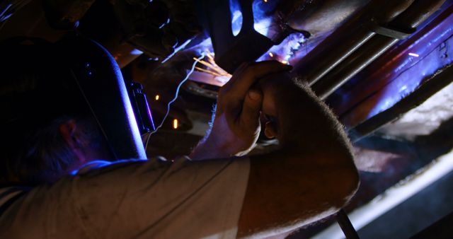 Industrial Worker Welding in Dark Mechanic Workshop - Download Free Stock Images Pikwizard.com