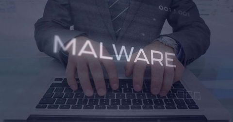 Businessman typing on laptop with malware overlay highlighting cybersecurity threat and data risk