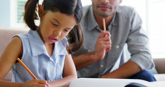 Father Guiding Daughter with Homework at Home - Download Free Stock Images Pikwizard.com