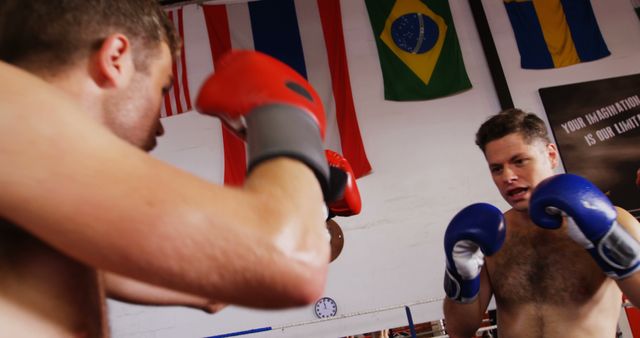 Two Men Boxing in Gym with International Flags in Background - Download Free Stock Images Pikwizard.com