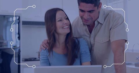 Couple collaborating on laptop in modern kitchen with circuit overlay for remote work