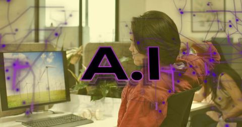 Woman in modern office viewing wind turbines on monitor