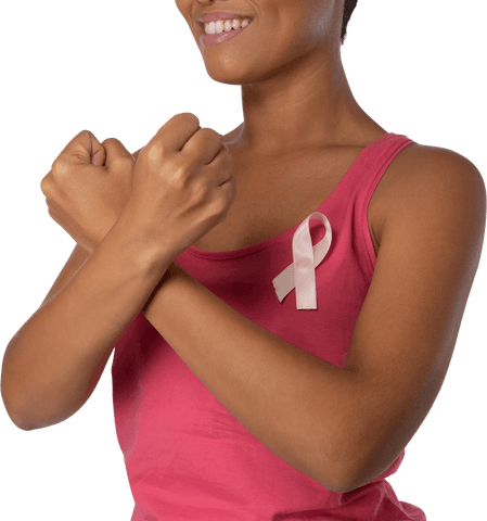 Smiling woman with pink ribbon on shirt promoting breast cancer awareness