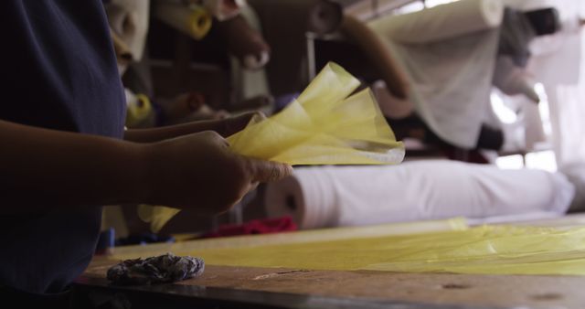 Person Handling Yellow Fabric in Textile Shop - Download Free Stock Images Pikwizard.com