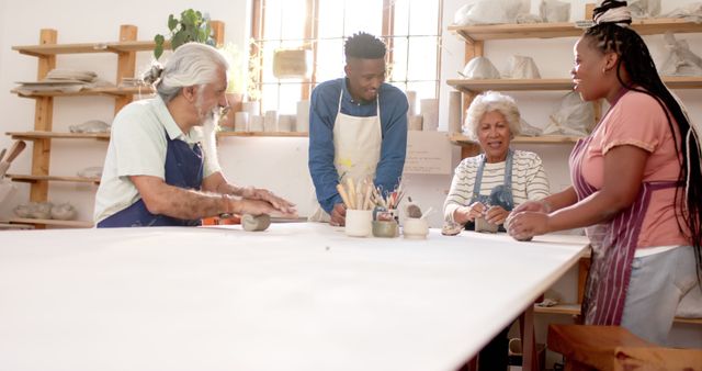 Diverse group of people engaging in pottery workshop - Download Free Stock Images Pikwizard.com