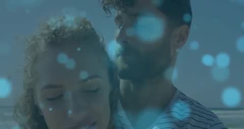 Romantic Couple Embracing with Bokeh Effect on Beach