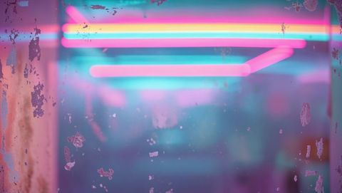 Vibrant neon colors behind distressed glass in nightclub scene