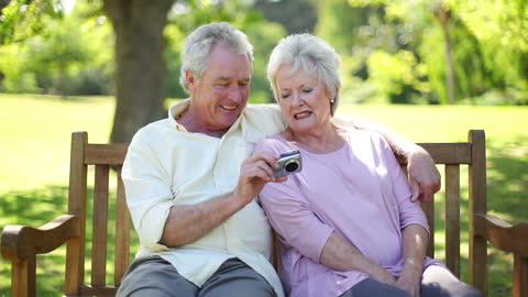 Senior Couple Enjoying Time in the Park with Camera