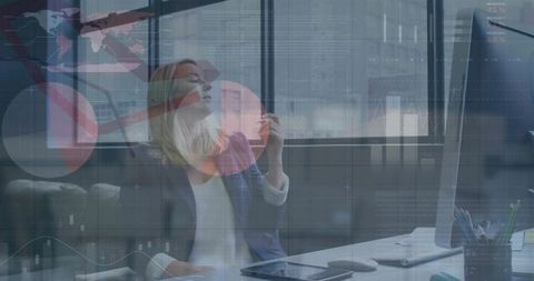 Mature businesswoman pausing at desk holding pen looking up with data overlay