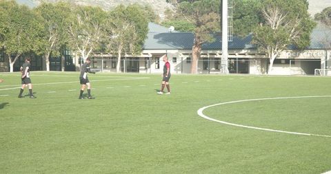 Soccer Players Practicing on Sunny Day in Open Field
