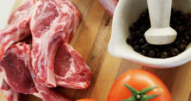 Fresh Raw Lamb Chops with Black Pepper and Tomatoes on Wooden Board - Download Free Stock Images Pikwizard.com